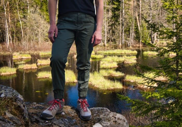 kühl air resistor air jogger outdoor pants being worn on a hike next to a lake in hot weather