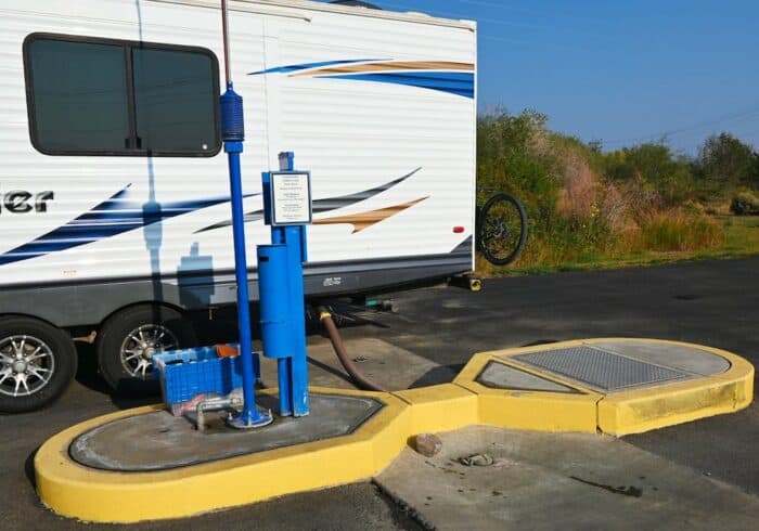 travel trailer at an rv dump station dumping the black tank to maintain the holding tanks