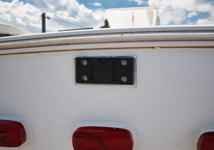 Auto Vox solar RV backup camera mounting bracket on a 5th-wheel RV trailer. 