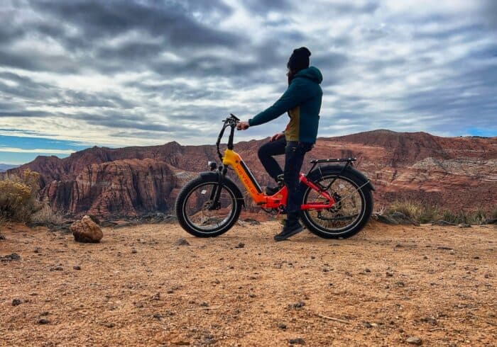 woman riding a heybike horizon folding electric bicycle on a dirt bike trail