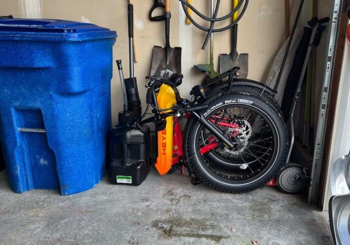 HeyBike Horizon electric bike folded and tucked away in a small garage.