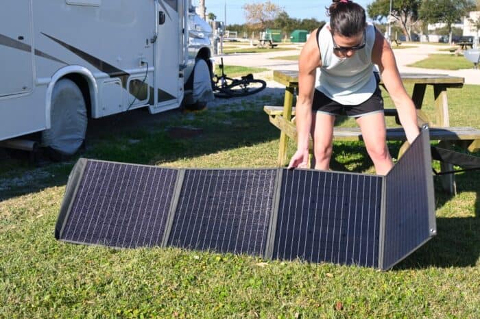 Jenni unfolding a portable foldable solar panel