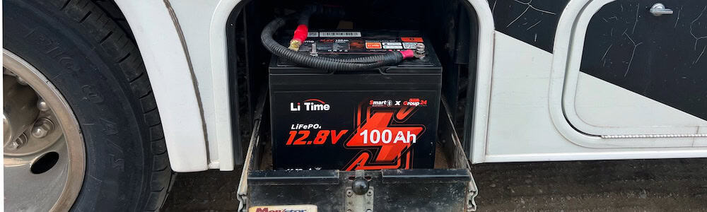 RV battery compartment with a 12.8V 100Ah AGM lithium battery installed in a motorhome