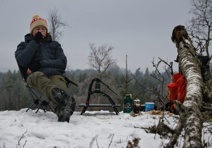 Woman drinking coffee brewed by the Flair Go portable espresso machine. 
