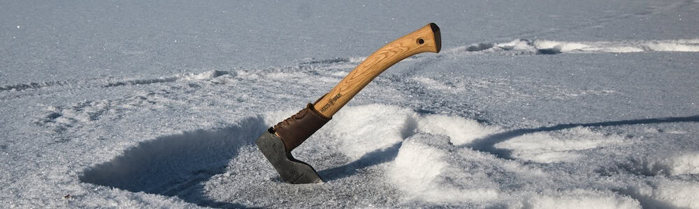 Dvardala axe by hults bruk being used to chop ice on a winter day in Sweden
