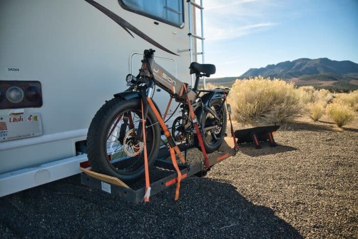 jasion hunter pro folding ebike strapped to a cargo rack behind an rv